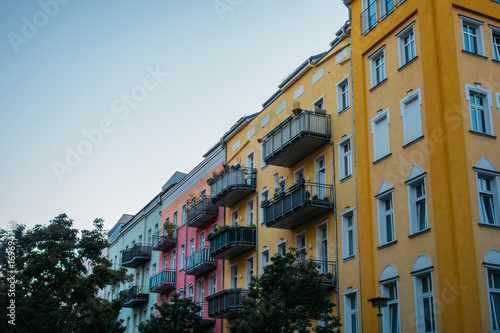 orange, pink and grey facaded buildings in a row at berlin