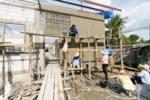 Blurry Background of Foreign workers are working in the construction site. Migrant workers are very popular in construction. Because apart from inexpensive labor is diligence. © Supak