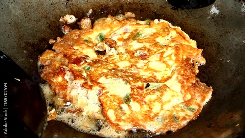 fryin omelet in pan photo