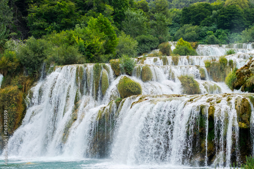 Nature landscape of waterfall cascade in the Croatia. National park Krka is popular travel placewith waterfalls in Europe. Mountain forest waterfall landscape.