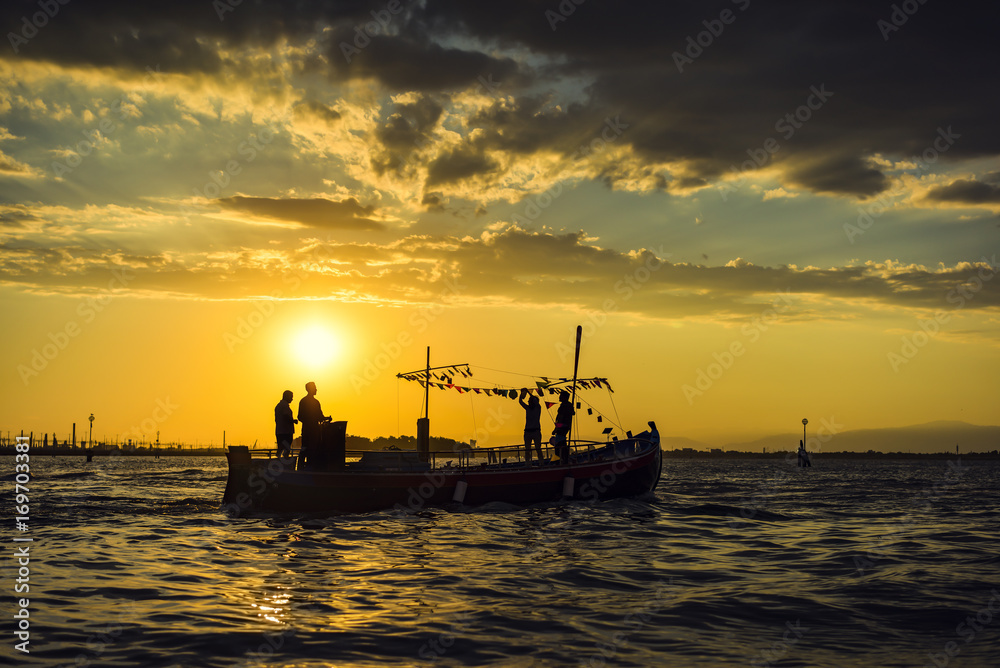 Sea sunset image. silhouette of the boat on summer sunset background.