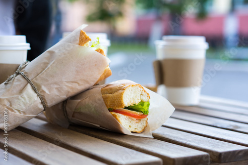 Sandwich with ham, cheese, tomato slice and lettuce leaf