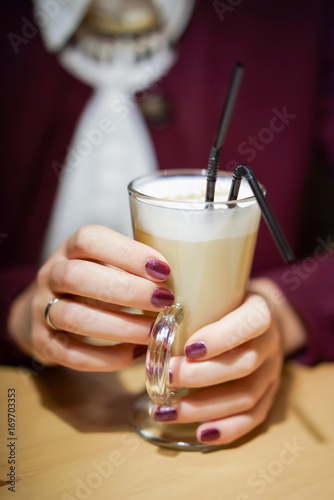 Close up shot of latte with a woman hands