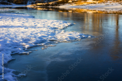 Ice and snow on a frozen lake in a winter sunny day