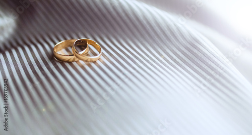 Wedding rings on fabric in stripes