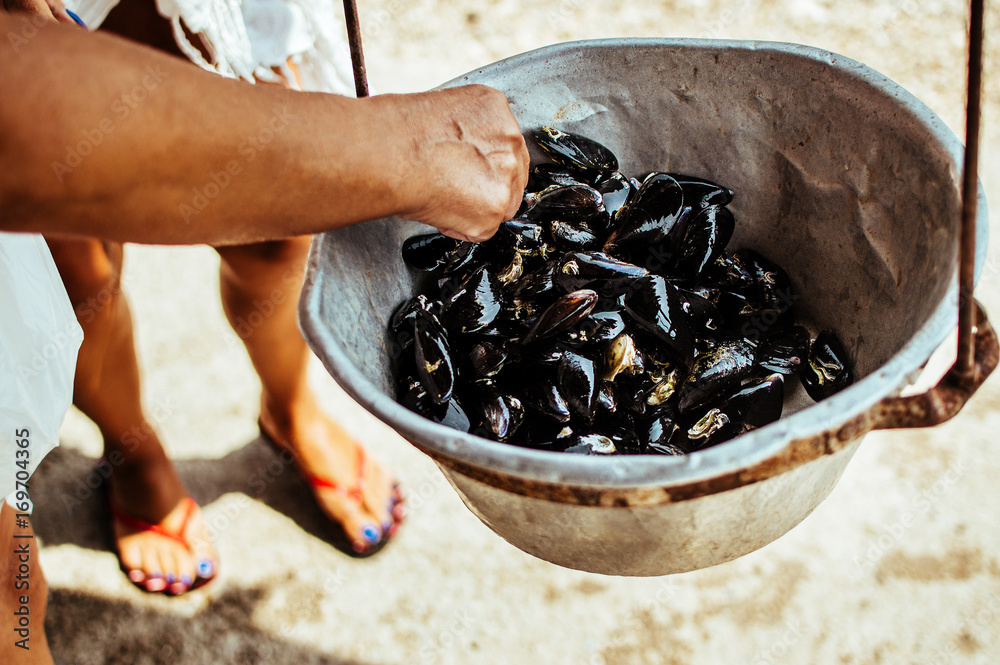 Man cooking mussels on pot. Man cooking mussels on pot.