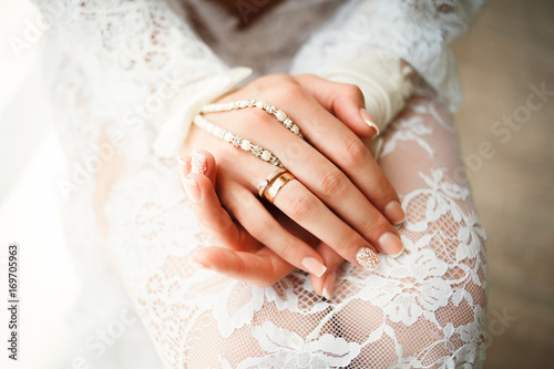 Gold wedding rings in the hands of bride