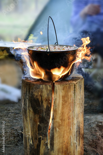 Cooking in cauldron on Finnish candle