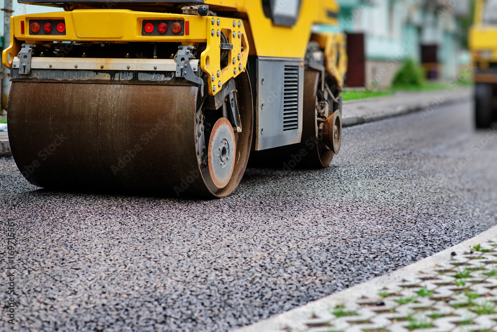 Background of asphalt roller that stack and press hot asphalt. Road repair machine