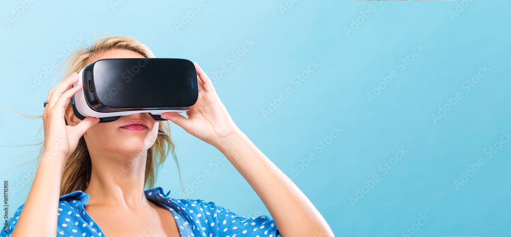  Happy young woman using a virtual reality headset