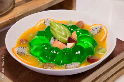  lemon jelly and fresh fruit in white bowle photo