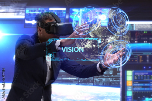Business, Technology, Internet and network concept. Young businessman working in virtual reality glasses sees the inscription: Vision