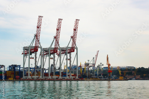 Large cargo cranes at the seaport, on the coast. photo