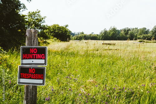 No hunting and no trespassing signs at the meadow in the countryside Ontario, Canada