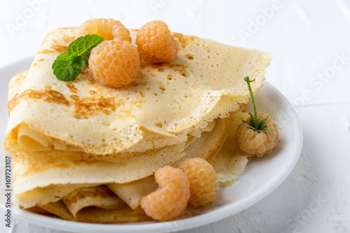 Homemade  crepes served with fresh yelllow raspberries