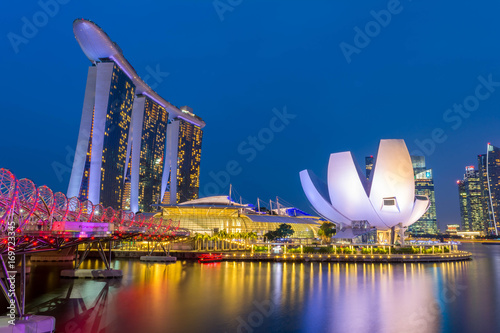Singapore, Singapore - August 24, 2017: View at the Marina Bay in Singapore during the night with the iconic landmarks of The Helix Bridge.