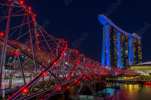 Singapore, Singapore - August 24, 2017: View at the Marina Bay in Singapore during the night with the iconic landmarks of The Helix Bridge.