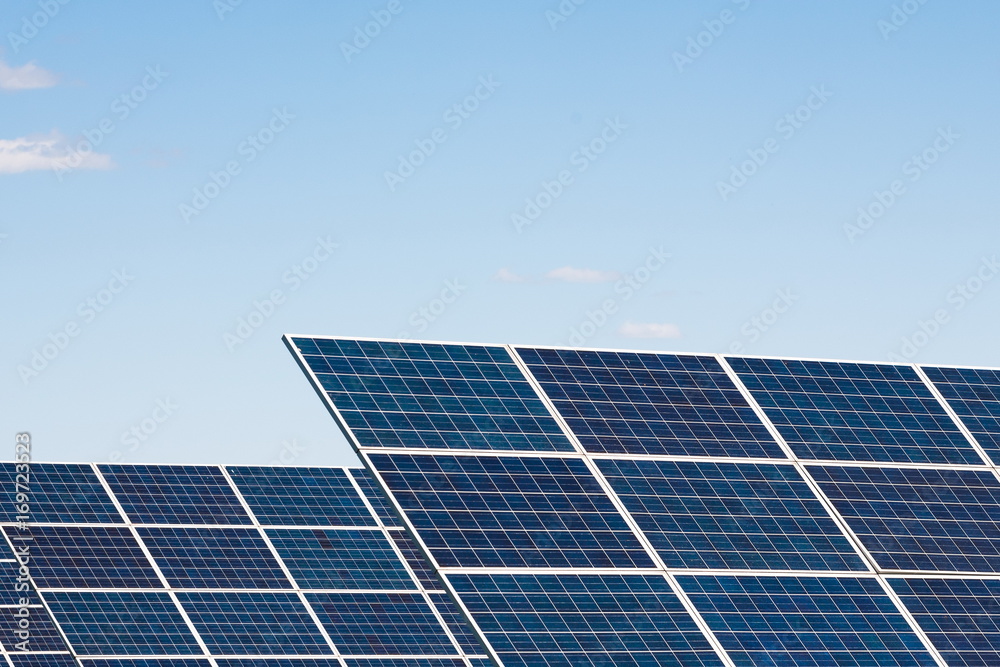 Solar panels against blue sky background Solar panels against blue sky background