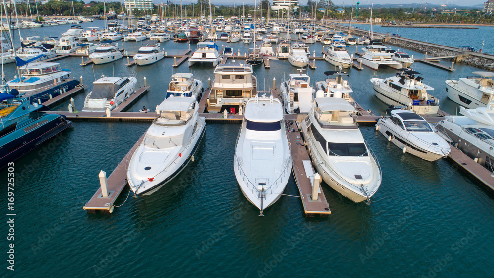 Obraz premium Pier speedboat. A marina lot. This is usually the most popular tourist attractions on the beach.Yacht and sailboat is moored at the quay.Aerial view by drone.Top view.