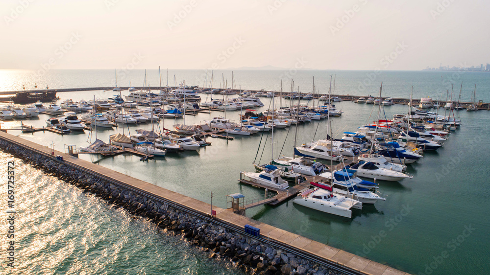 Obraz premium Pier speedboat. A marina lot. This is usually the most popular tourist attractions on the beach.Yacht and sailboat is moored at the quay.Aerial view by drone.Top view.