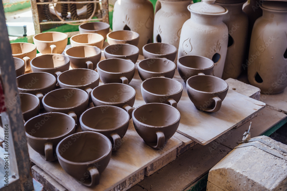 Drying after molding unbaked pottery in workshop.