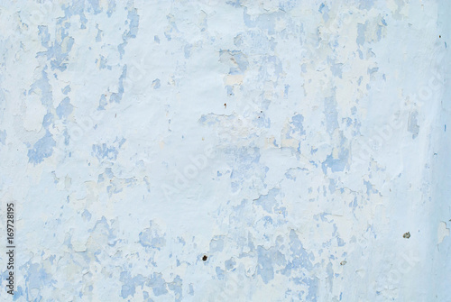Old white with blue wall with cracks for background or texture horizontal.