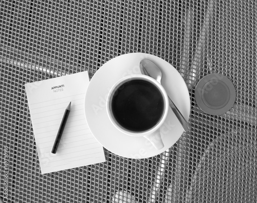 A cup of cafee with pencil and a sheet  of white paper Black&white) photo