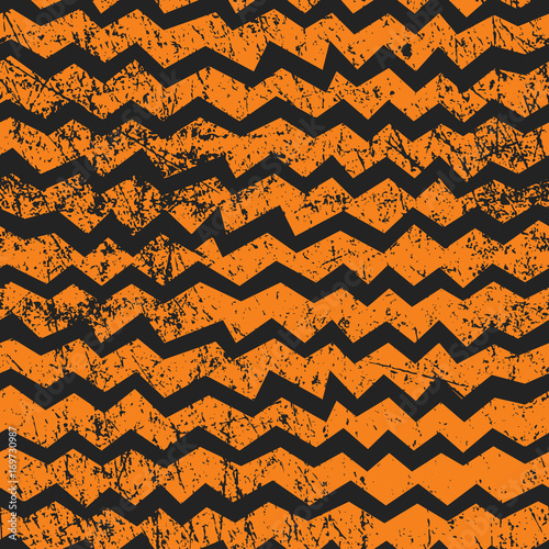 Vector seamless Halloween chevron pattern. Black and orange zigzag lines with shabby texture. Good for Halloween cards, polygraphy, stuff.
