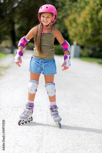 Female child roller skating in a park