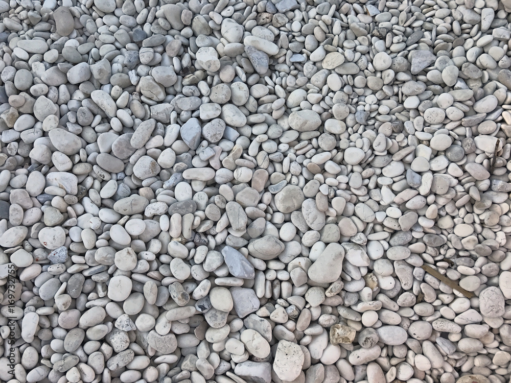 Small white stone of a beach. Suitable to be used like a background. Small white stone of a beach. Suitable to be used like a background.
