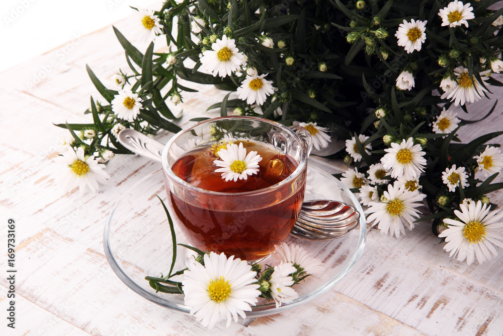cup of tea with chamomile flowers on rustic background cup of tea with chamomile flowers on rustic background