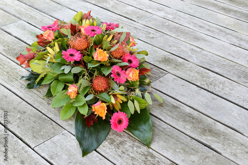 Flower arrangement on wooden background.