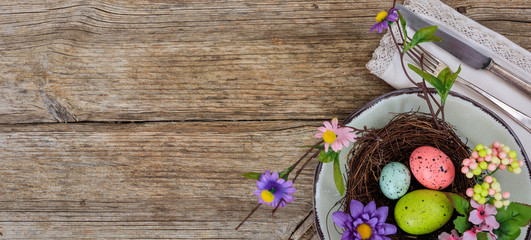 Easter eggs on a plate on wooden background