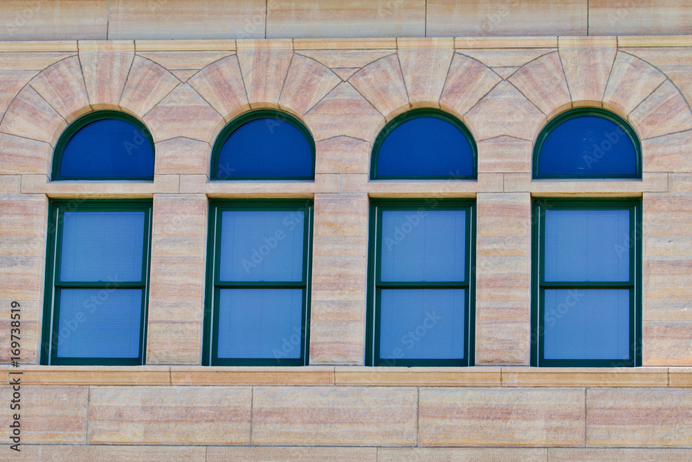 Fototapeta premium Four antique windows in a limestone building