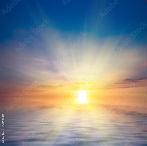 Beautiful sunset at the sea and sun with rays.