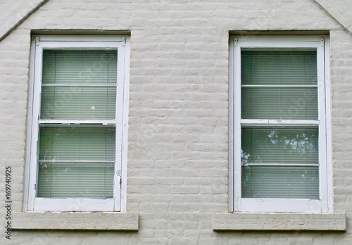 Gray brick wall with two white windows