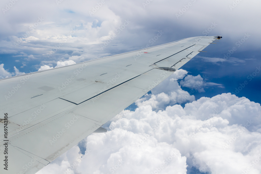 Fototapeta premium Wing of an airplane. Photo applied to tourism operators. Traveling concept