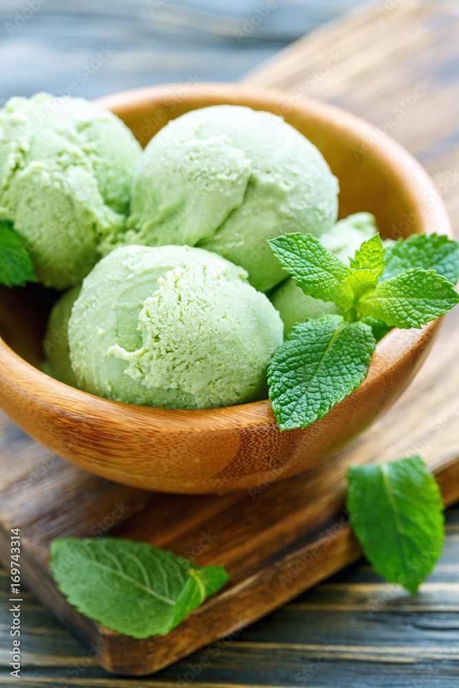 Homemade mint ice cream in a wooden bowl. Homemade mint ice cream in a wooden bowl.