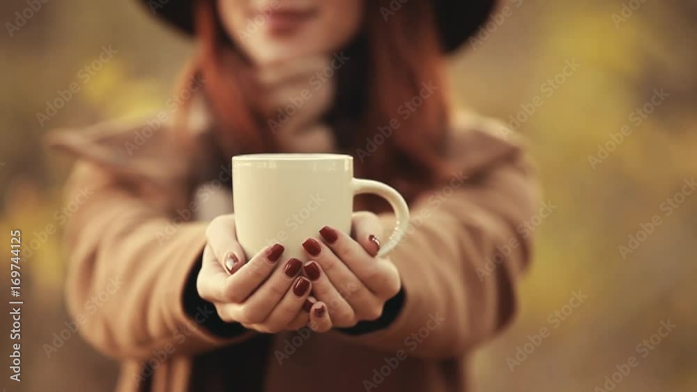 Video of Young woman with cup of coffee or tea at autumn outdoor Video of Young woman with cup of coffee or tea at autumn outdoor