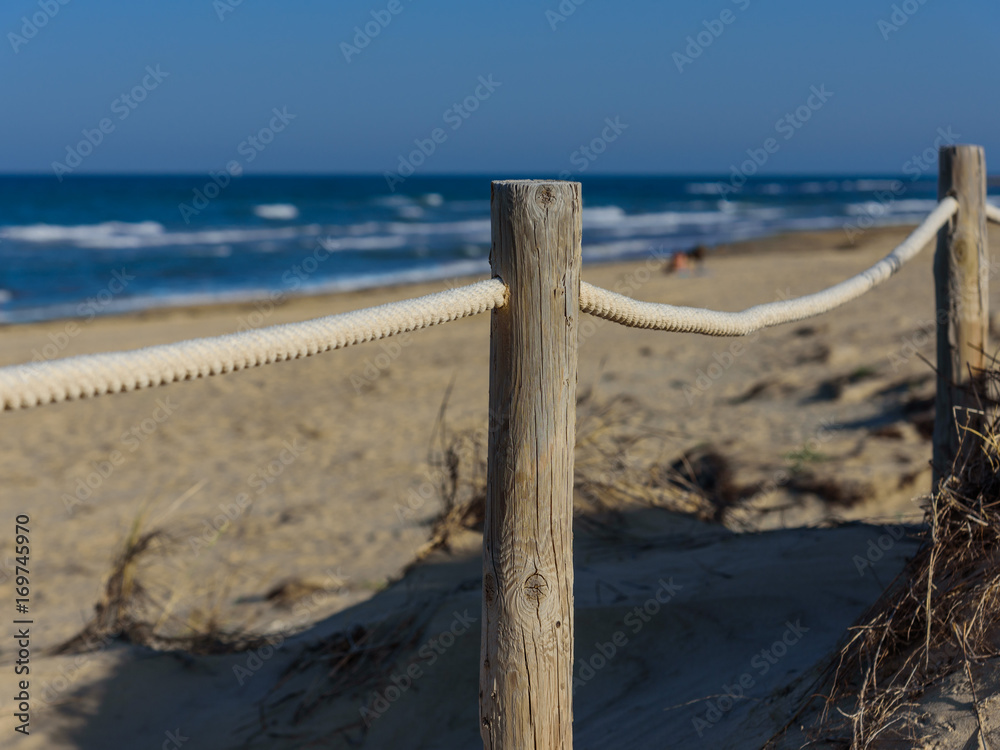 Rope fence on the sandy beach of La Mata. Sunset on the beach. Blurred unfocused background 01 Rope fence on the sandy beach of La Mata. Sunset on the beach. Blurred unfocused background 01