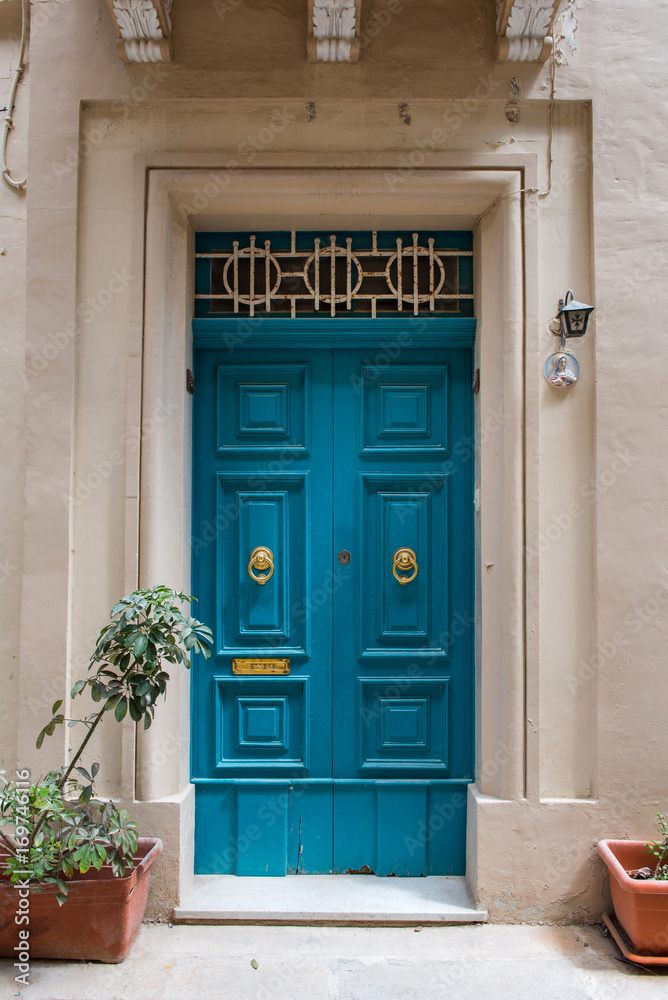 Traditional wooden painted blue door in Malta