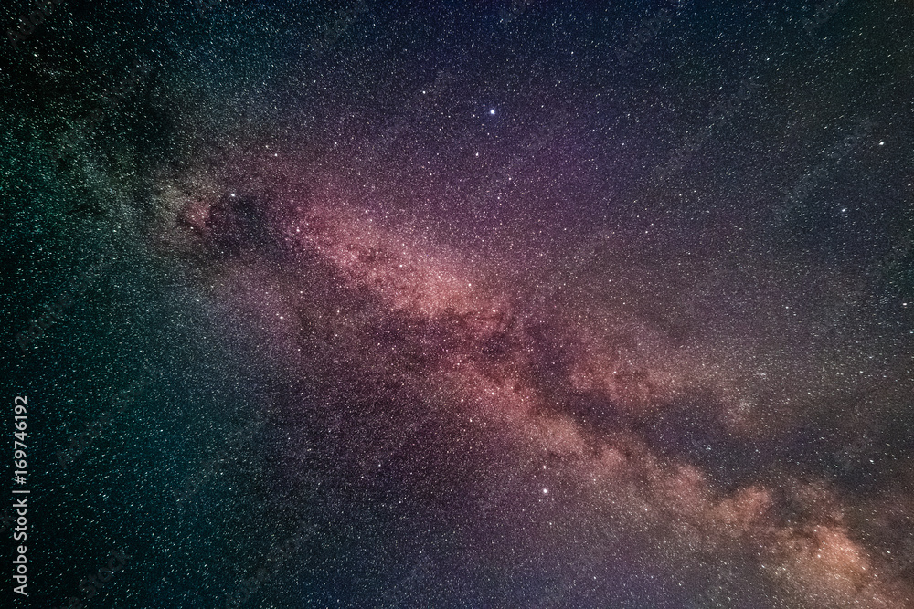 Fototapeta premium The Milky Way and the Summer Triangle consisting of the bright stars Altair, Deneb, Vega, as seen from the Luitpold Tower in the Palatinate Forest near Merzalben in Germany.