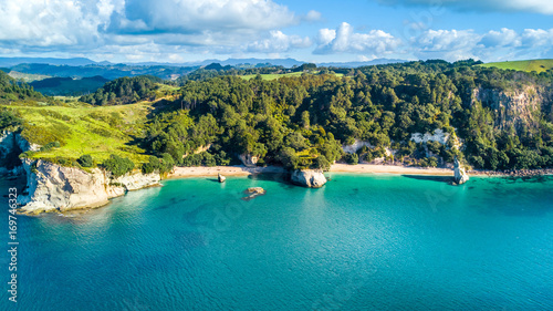 Aerial view on a remote ocean coast with small coves and mountains on the background. Coromandel, New Zealand. photo
