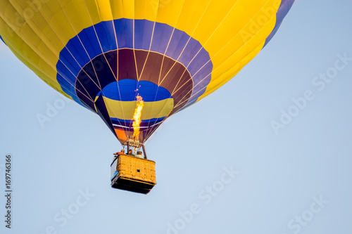 Colorful of Hot air balloon with fire and blue sky background