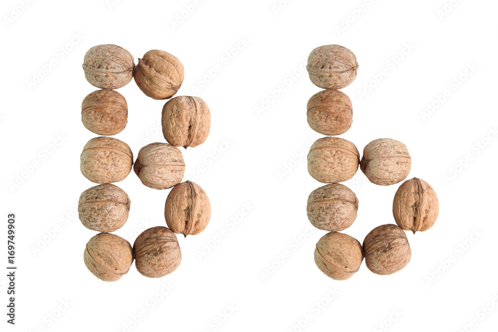 The group of walnuts on white background, making letter B. Studio shot The group of walnuts on white background, making letter B. Studio shot