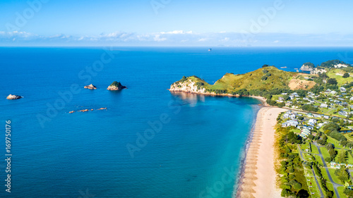 Aerial view on beautiful harbour with sunny beach and surrounding hillside, Coromandel, New Zealand
