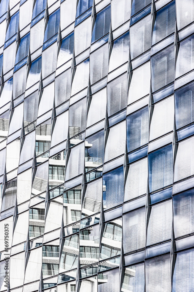 Blue sky reflected in mirrored windows of modern building. Details. Berlin, Germany Blue sky reflected in mirrored windows of modern building. Details. Berlin, Germany