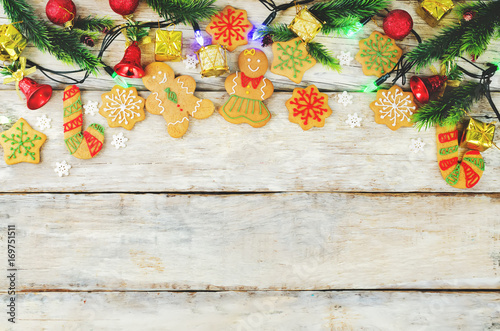Wood background with gingerbread cookies, Christmas tree and Christmas light