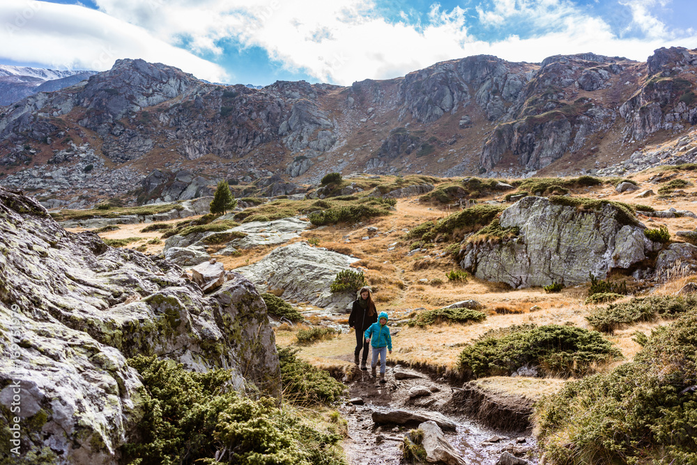 Woman with son hiking the mountains having a good time