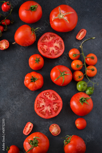 Fresh, juicy tomatoes on a black concrete background